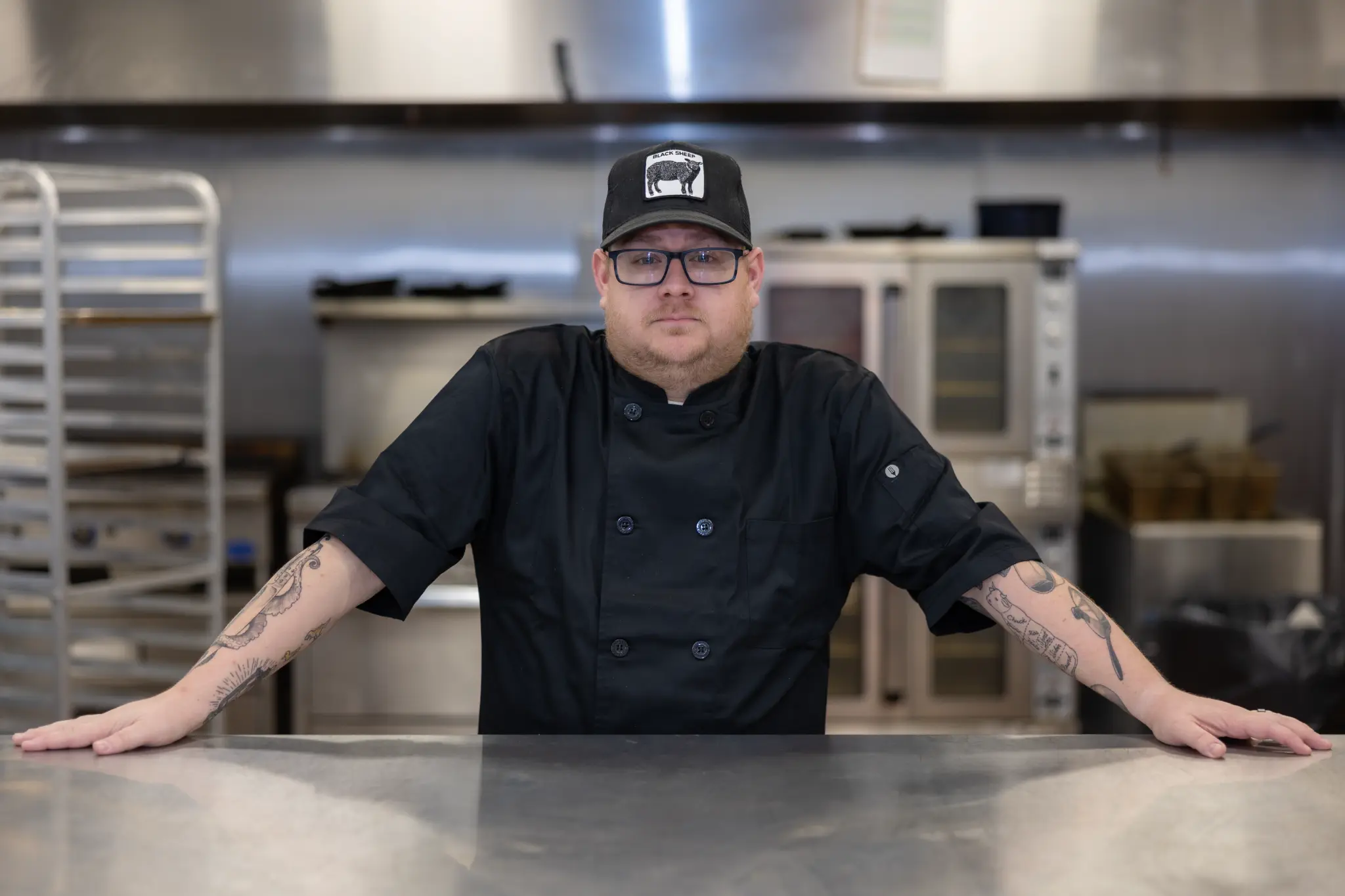 Chef Josh Bakken in his kitchen, confident pose at the counter