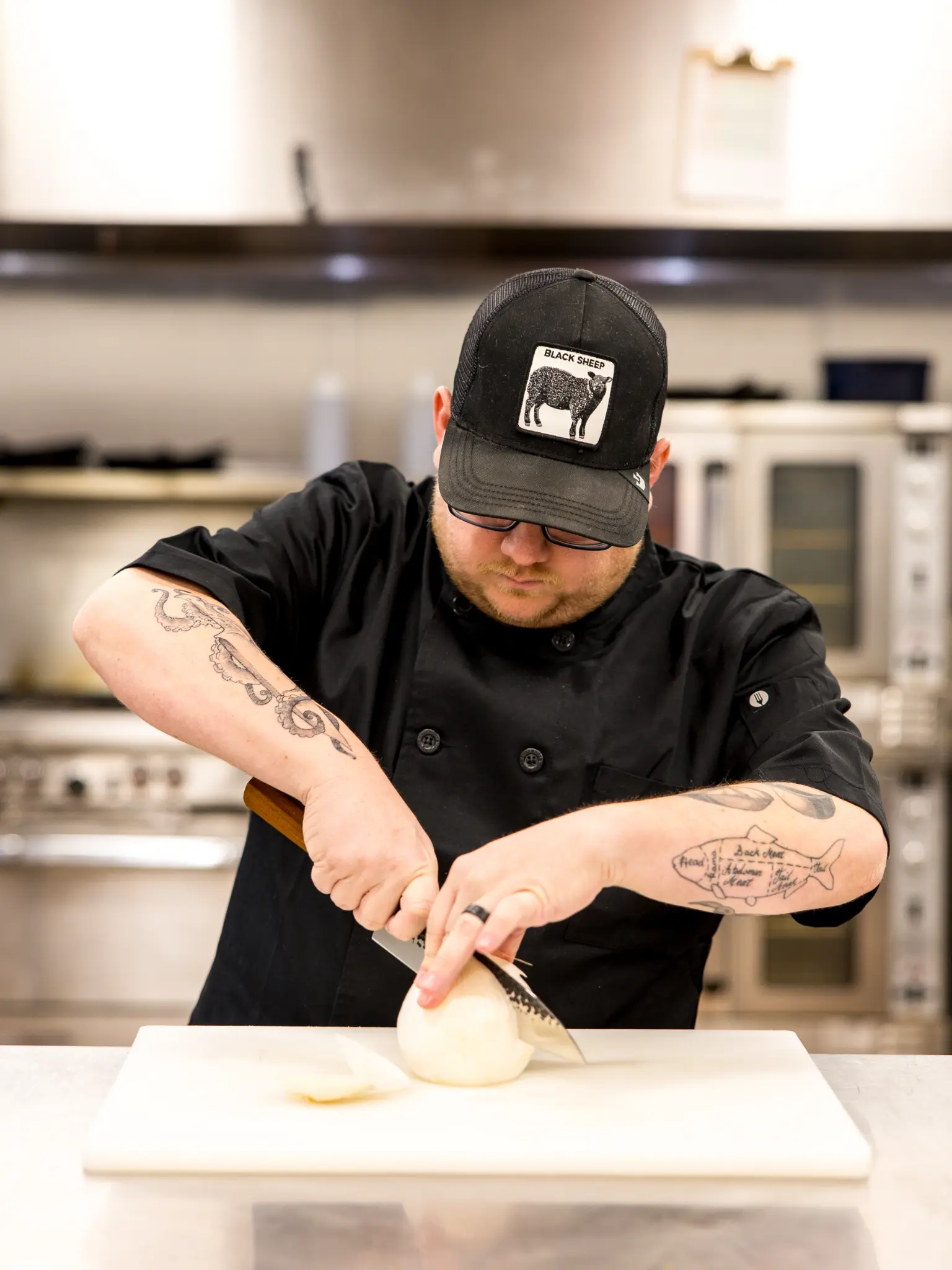 Chef Josh Bakken precision-cutting ingredients in a professional kitchen