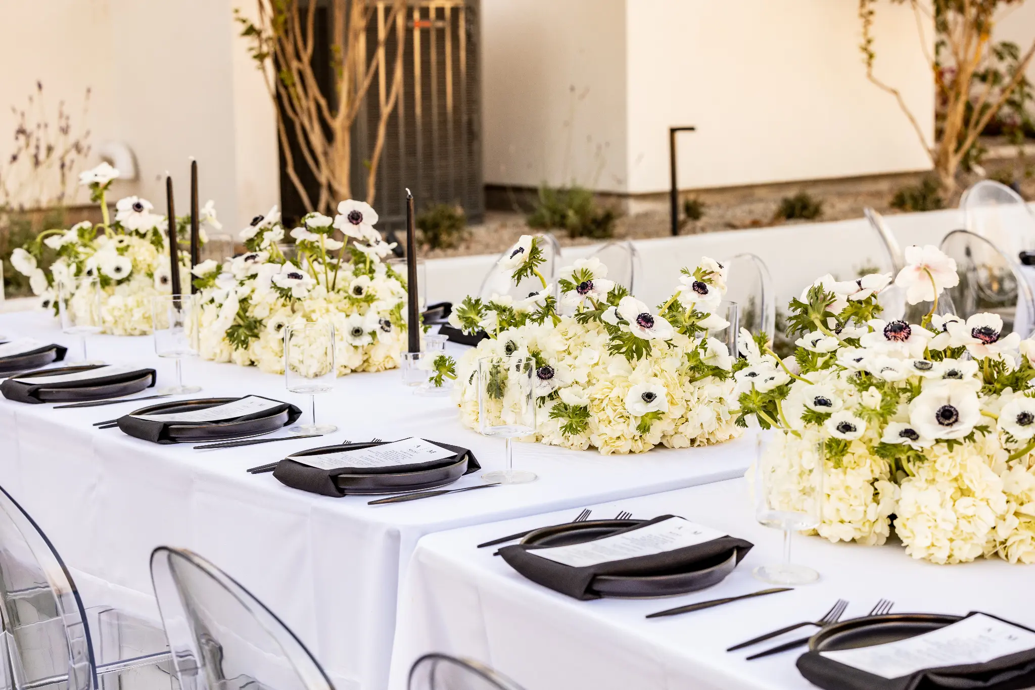 Elegant wedding table with white anemone florals and black place settings