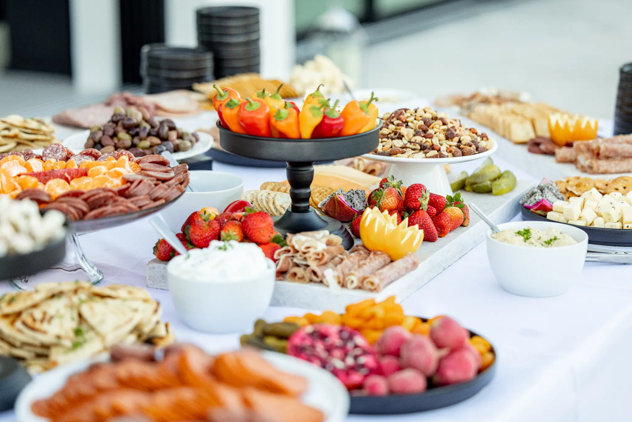 Stunning charcuterie and grazing table with strawberries, nuts, meats, and dips